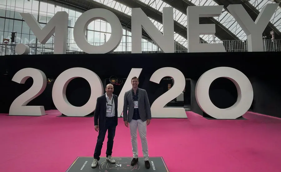 CEO Daniel Webber and Head of Commercial Ben Disley standing in front of the Money20/20 Europe sign